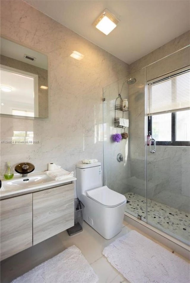 bathroom with vanity, toilet, and a shower with shower door