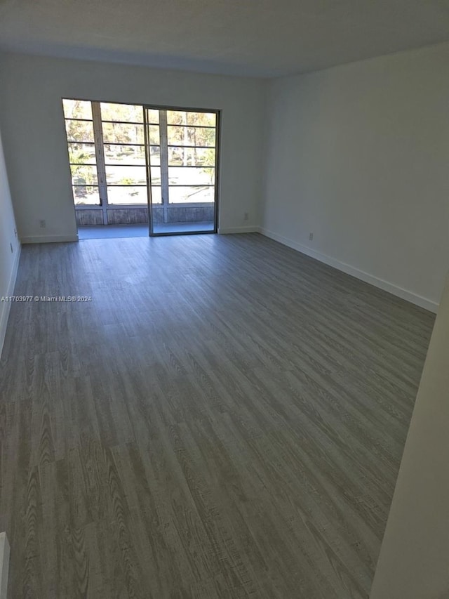 unfurnished room featuring dark wood-type flooring