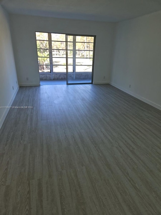 empty room featuring dark hardwood / wood-style flooring