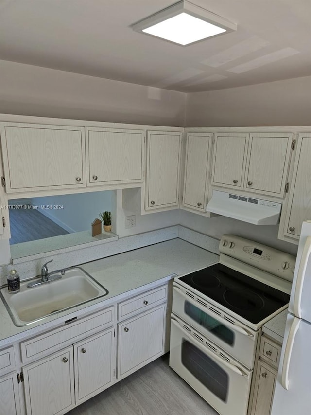 kitchen featuring light wood-type flooring, white appliances, sink, and range hood