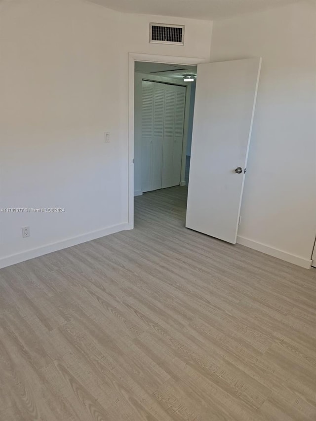 unfurnished room with light wood-type flooring