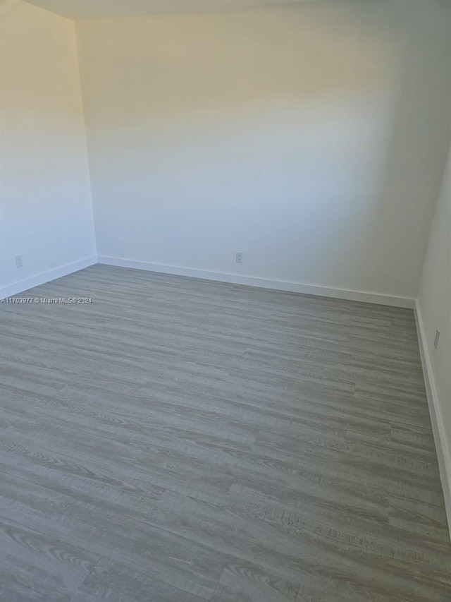 unfurnished room with light wood-type flooring