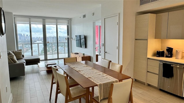 dining space with light hardwood / wood-style flooring and floor to ceiling windows