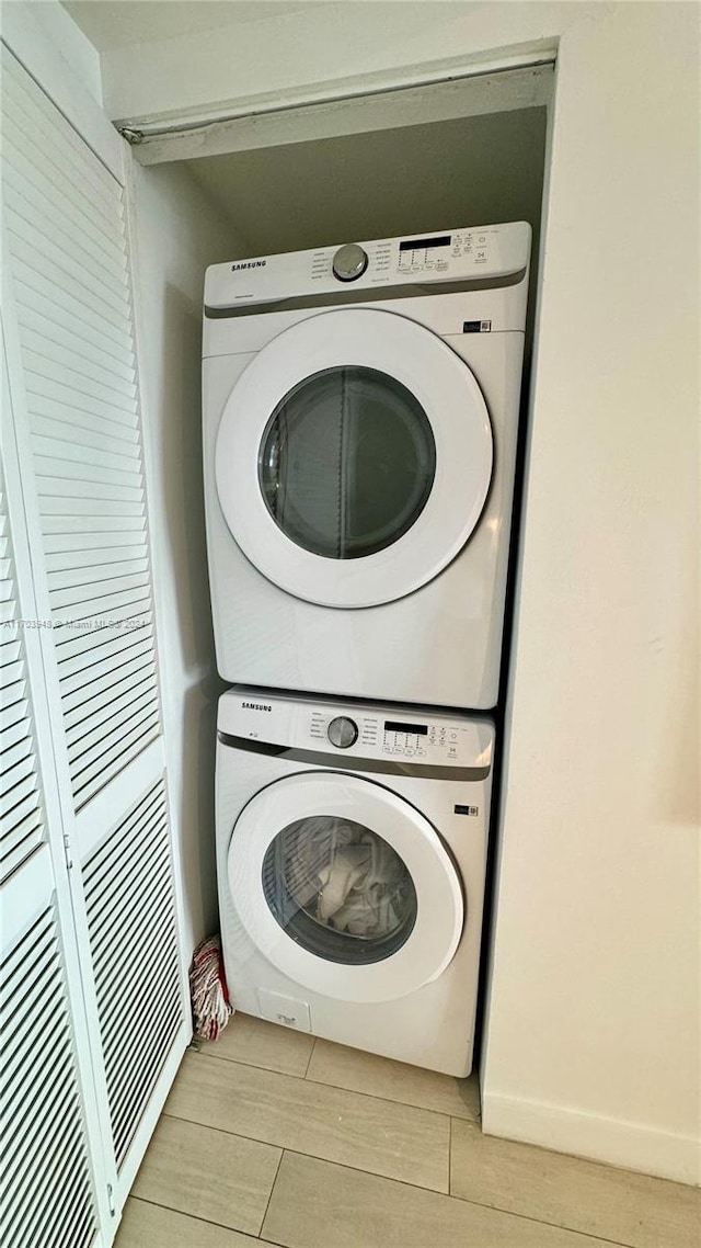 laundry area with stacked washer / dryer