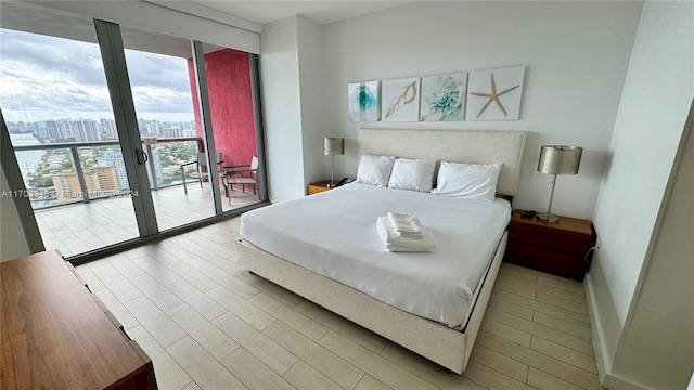 bedroom featuring access to outside and light hardwood / wood-style flooring