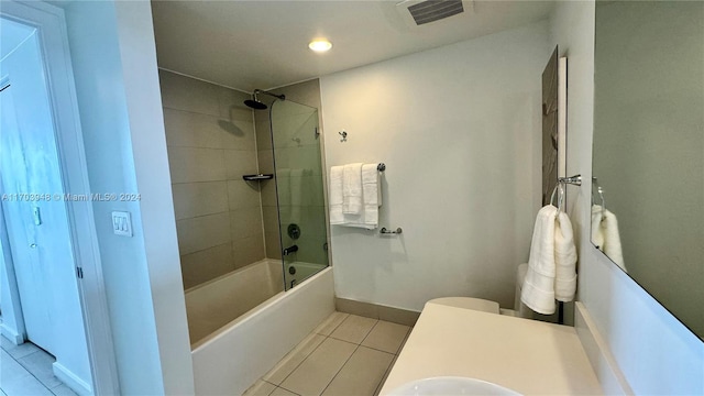 full bathroom with tile patterned floors, tiled shower / bath combo, toilet, and sink