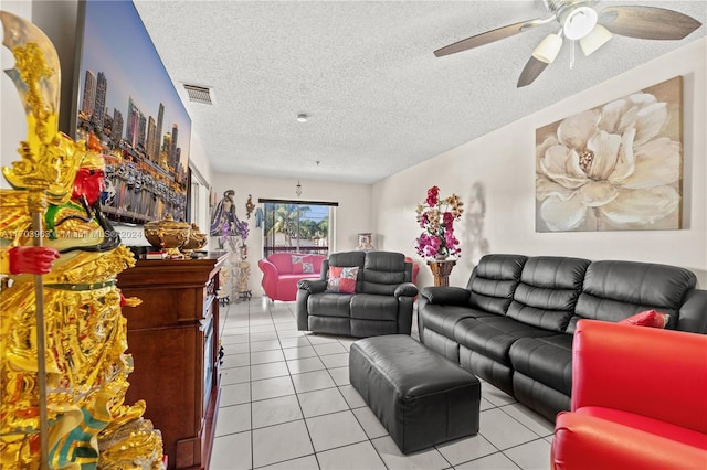 living room featuring a textured ceiling, ceiling fan, and light tile patterned flooring