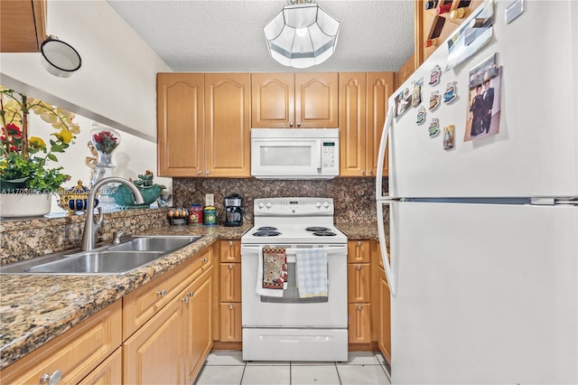 kitchen with white appliances, sink, decorative backsplash, light tile patterned floors, and a textured ceiling