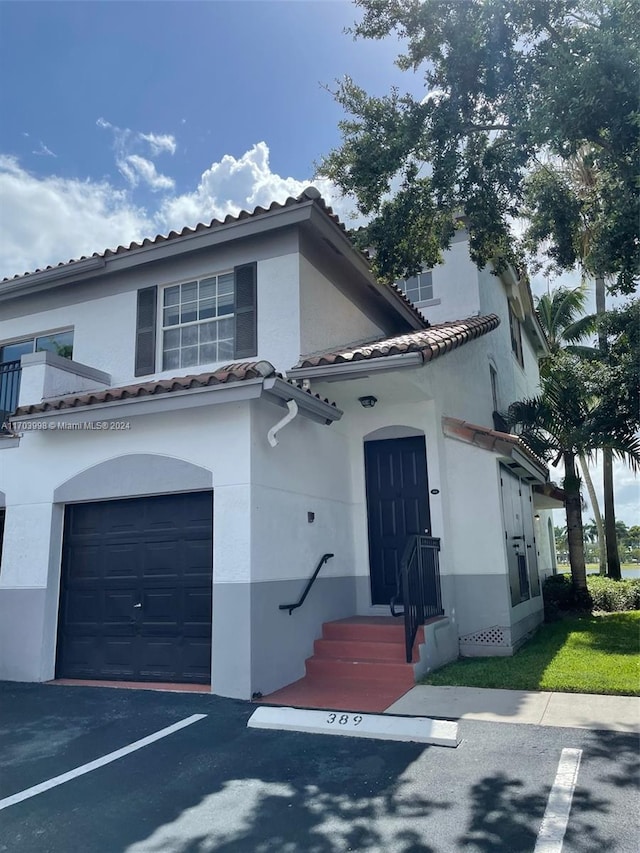 mediterranean / spanish house with a garage