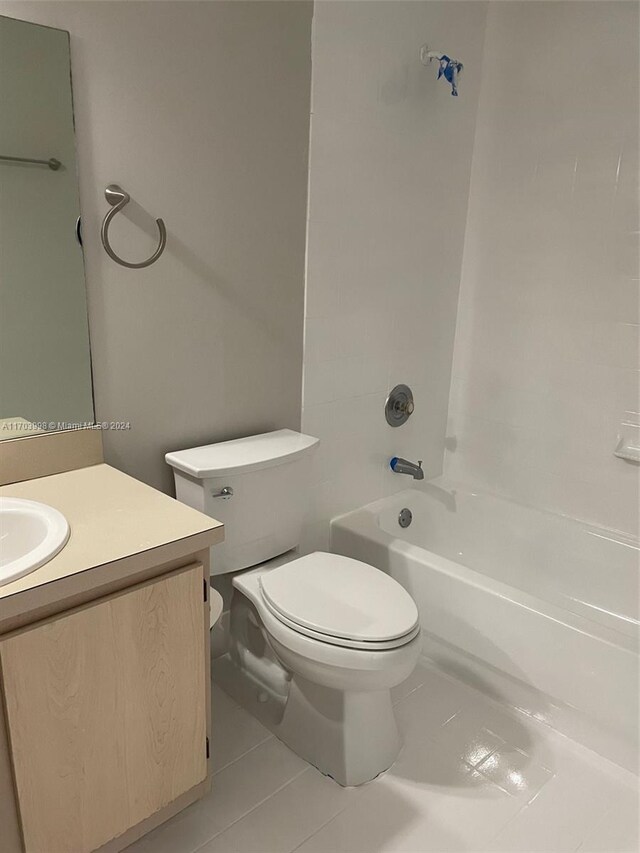 full bathroom featuring tile patterned floors, vanity, toilet, and  shower combination