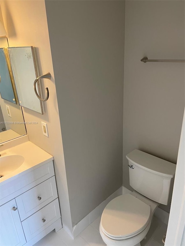bathroom with tile patterned flooring, vanity, and toilet