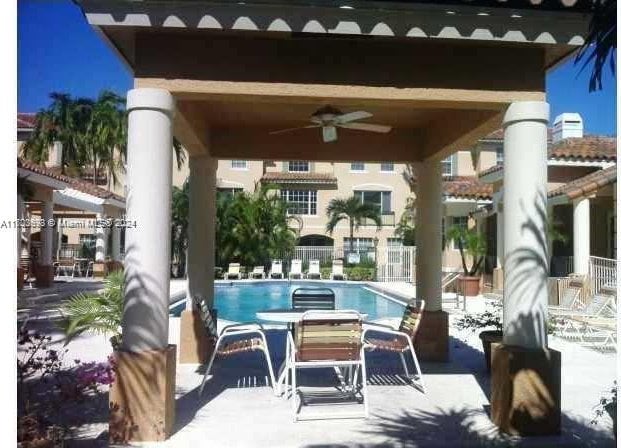 view of swimming pool with a gazebo and ceiling fan