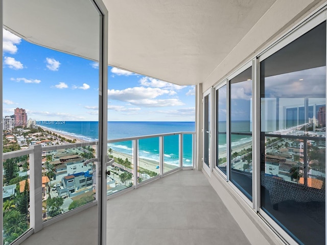 balcony with a beach view and a water view