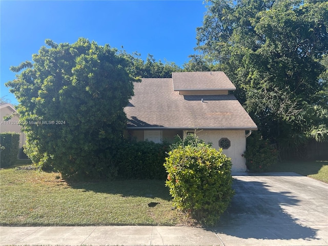 view of property exterior featuring a lawn