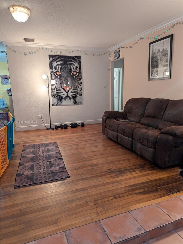 living room with crown molding and wood-type flooring