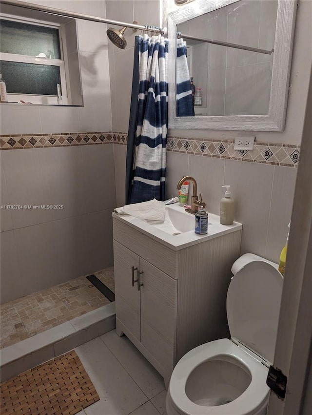 bathroom with tile patterned flooring, toilet, tile walls, and walk in shower