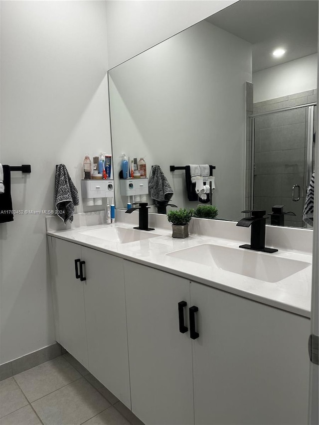 bathroom with vanity, tile patterned floors, and a shower with door