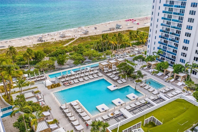 birds eye view of property featuring a water view and a view of the beach