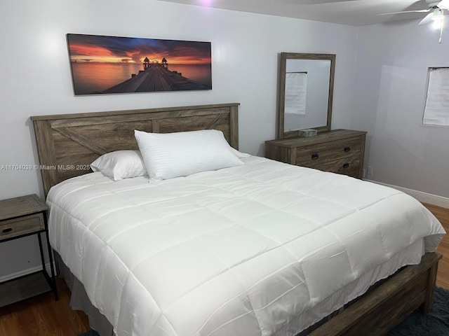 bedroom with baseboards and wood finished floors