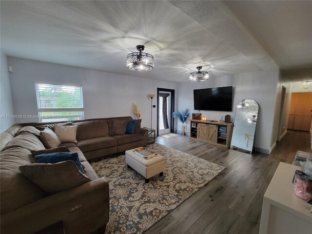 dining room with dark wood-type flooring and a textured ceiling