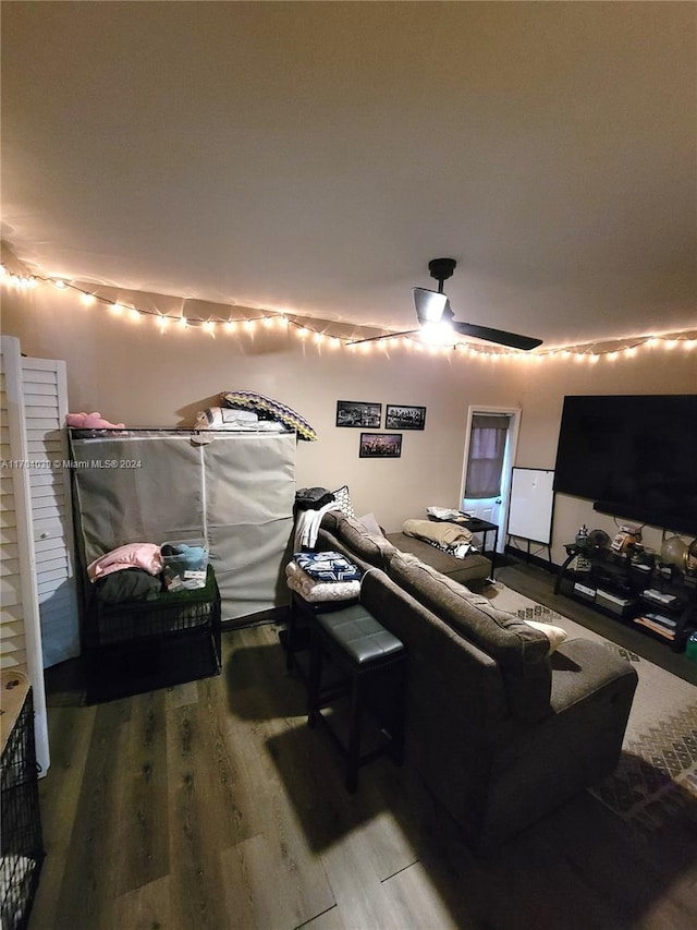 home theater featuring hardwood / wood-style flooring and ceiling fan