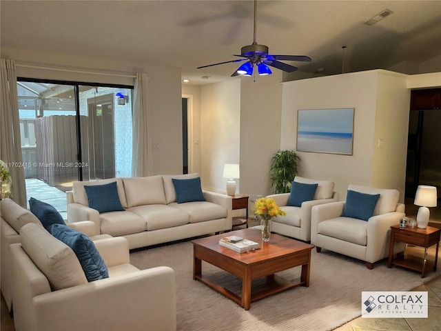 living room with tile patterned flooring and ceiling fan