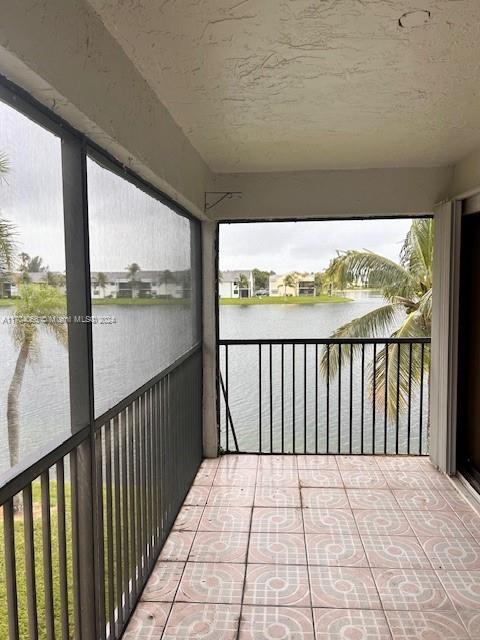 balcony featuring a water view