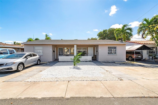 single story home featuring a carport