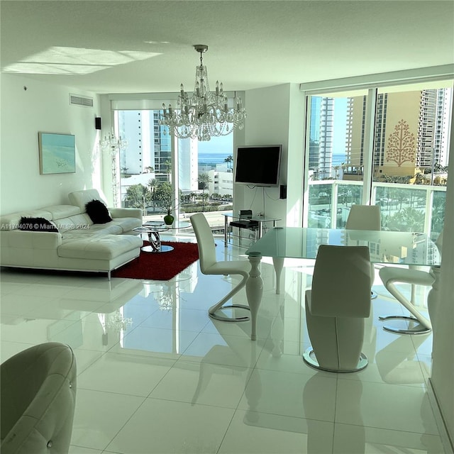 living room featuring plenty of natural light, light tile patterned floors, and a chandelier