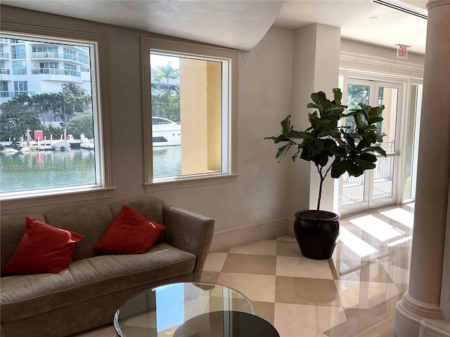 living area featuring french doors and a water view