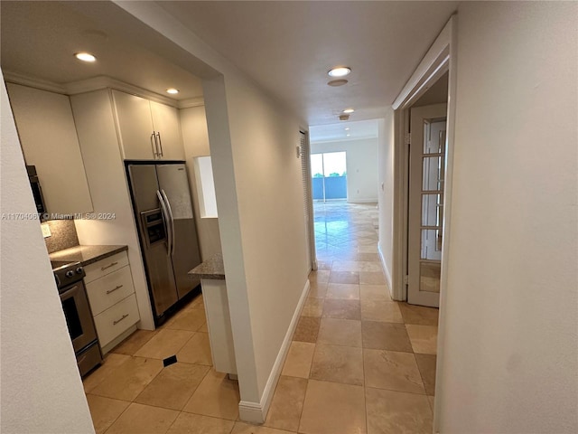 corridor featuring light tile patterned flooring