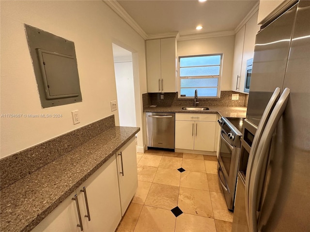 kitchen with appliances with stainless steel finishes, white cabinetry, crown molding, and sink