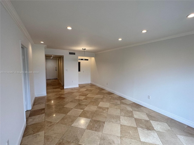 unfurnished room with crown molding