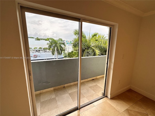 entryway featuring a water view and ornamental molding