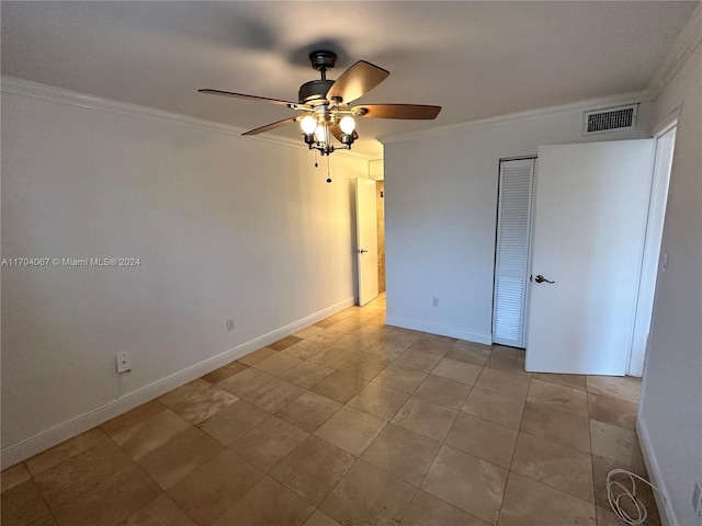 unfurnished bedroom with ceiling fan, a closet, and ornamental molding