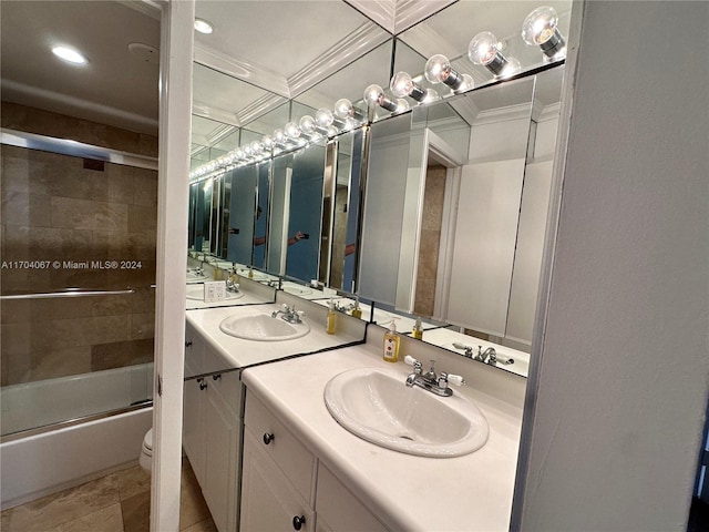 full bathroom with vanity, toilet, and bath / shower combo with glass door