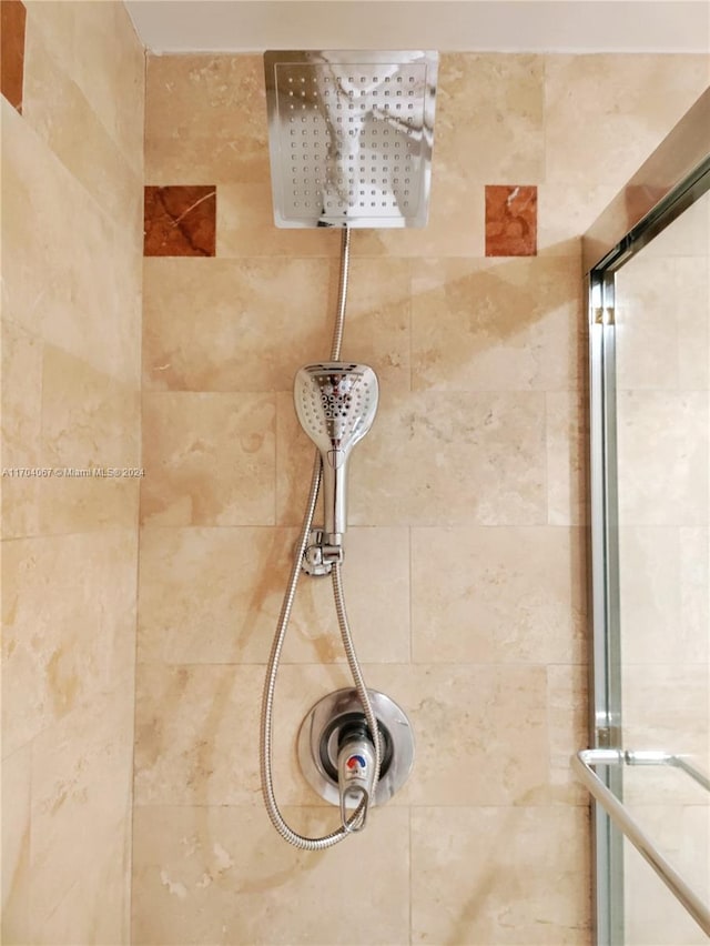 interior details featuring tiled shower