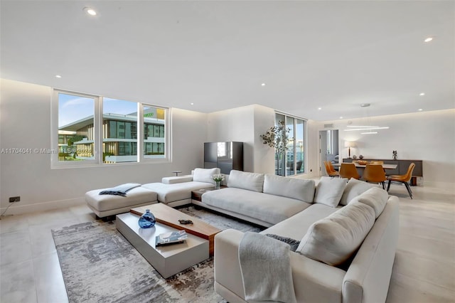 living room featuring plenty of natural light and light tile patterned floors