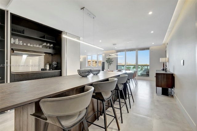 kitchen featuring decorative light fixtures and a breakfast bar area