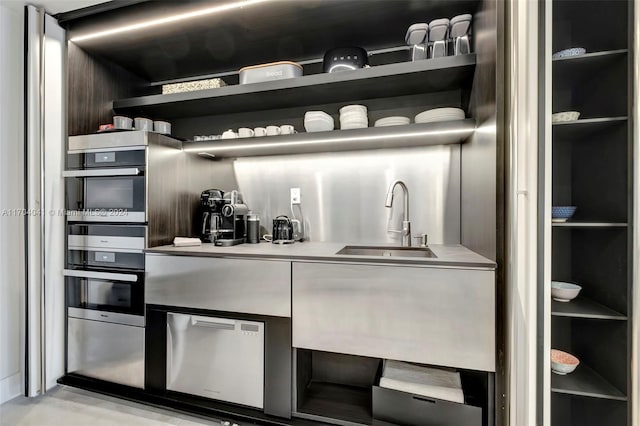 2301 Collins Ave Unit 634/635, Miami Beach, FL 33139 - kitchen with open shelves, light countertops, and stainless steel double oven