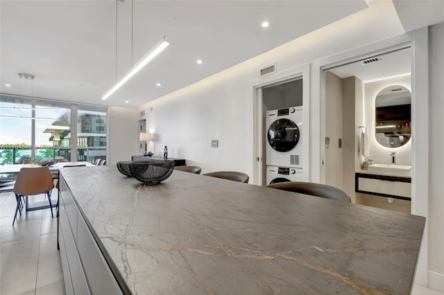 2301 Collins Ave Unit 634/635, Miami Beach, FL 33139 - dining room featuring stacked washer / dryer, recessed lighting, and light tile patterned floors