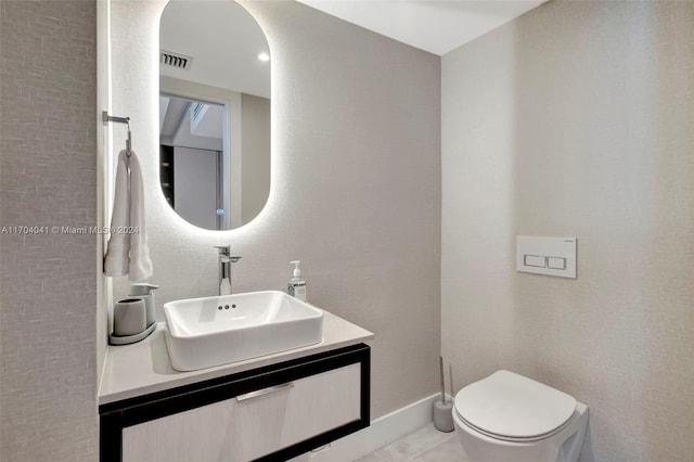 bathroom with tile patterned floors, vanity, and toilet