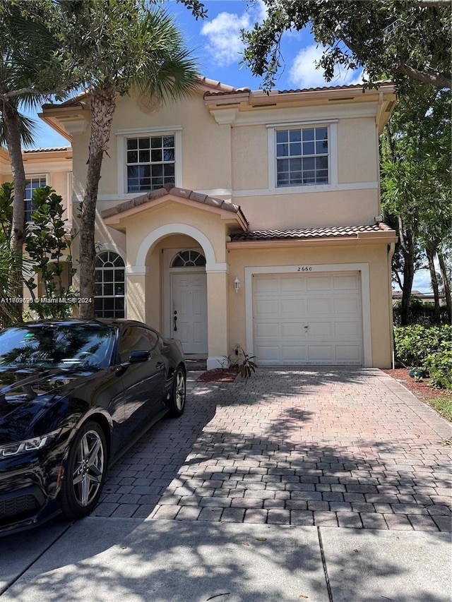 mediterranean / spanish-style house featuring a garage