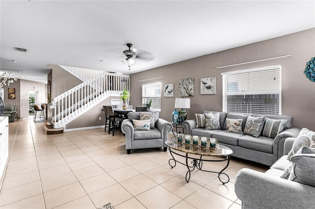 tiled living room with ceiling fan