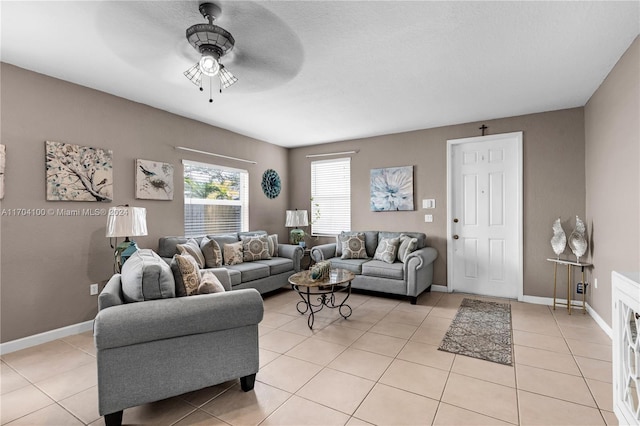 living room with ceiling fan and light tile patterned floors