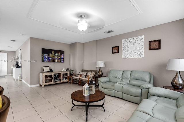 living room featuring light tile patterned floors and ceiling fan