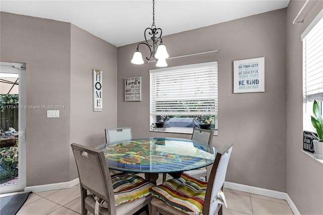 tiled dining space with a chandelier and plenty of natural light