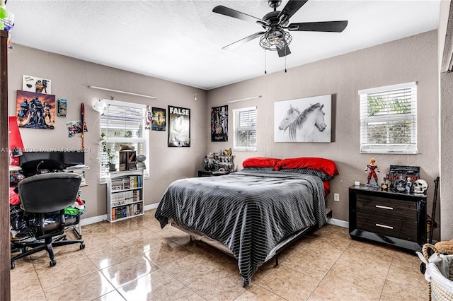 bedroom featuring multiple windows, ceiling fan, and tile patterned flooring