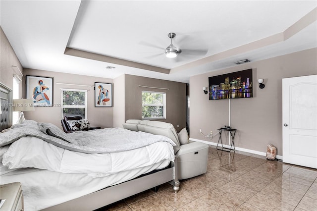 bedroom featuring a tray ceiling and ceiling fan