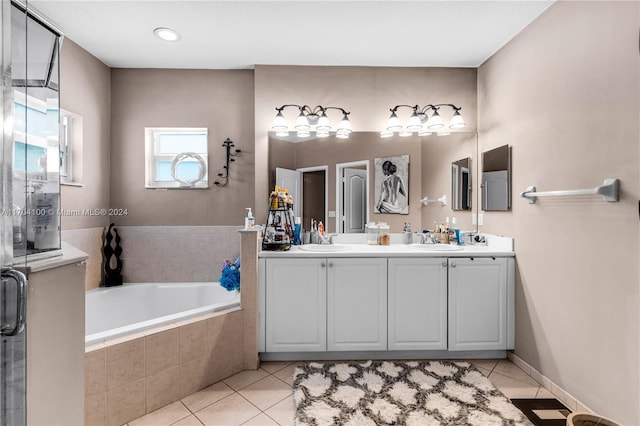 bathroom with tile patterned floors, vanity, and independent shower and bath